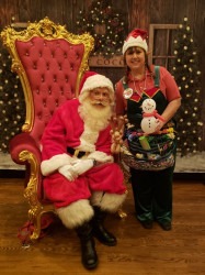 elf20with20Santa20JOhn20and20chair20and20backdrop 173225280 1 Santa John